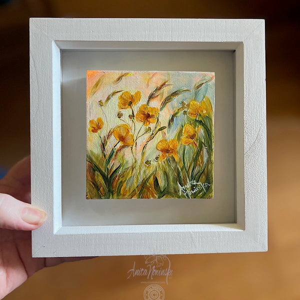 framed miniature oil painting of yellow buttercups in a sunlit meadow
