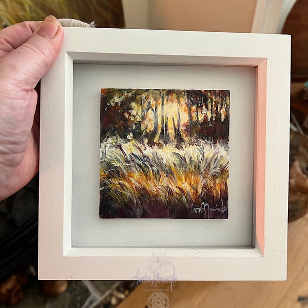 framed miniature oil painting of a winter garden with frosty grasses and sunlight filtering through trees by anita nowinska art