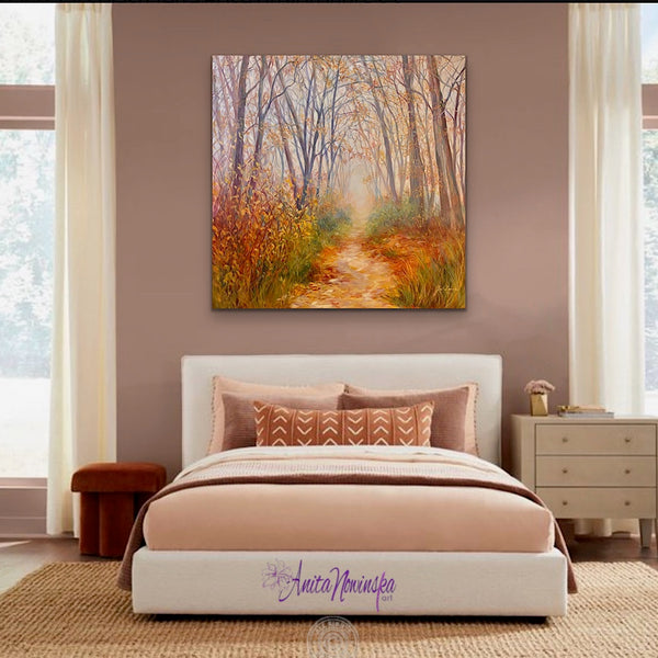 big landscape painting of an autumn woodland with a misty path by anita nowinska in a dusty pink bedroom